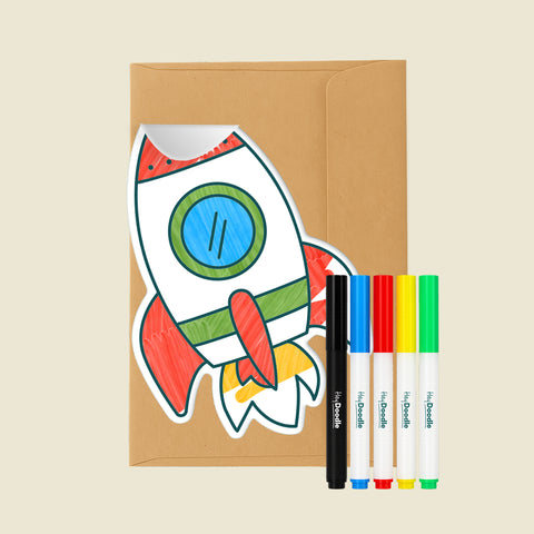 Rocket-shaped Reusable Gifting Card™, an envelope and five markers on a beige background