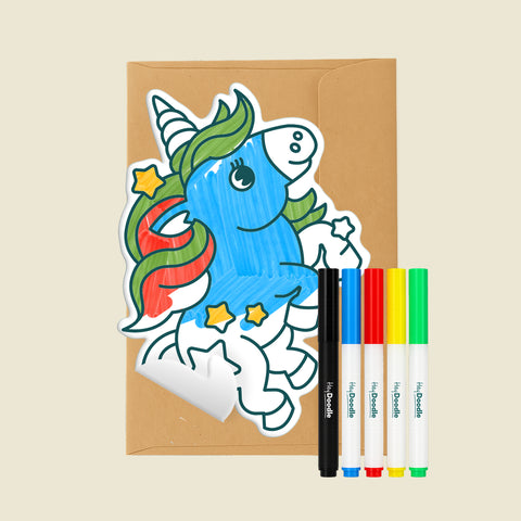Unicorn Reusable Gifting Card™ on a brown envelope with five markers