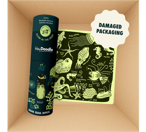 Mini Mats (Damaged packaging) featuring a dark green cylindrical silicone carry case and a square reusable silicone activity mat illustrated with glowing yellow deep-sea creatures for colouring.