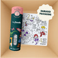 A teal cylindrical silicone canister and a rectangular silicone Mini Mats (Damaged packaging) activity mat featuring black-and-white line art of unicorns, mermaids, and castles, presented in a reusable silicone-friendly box.