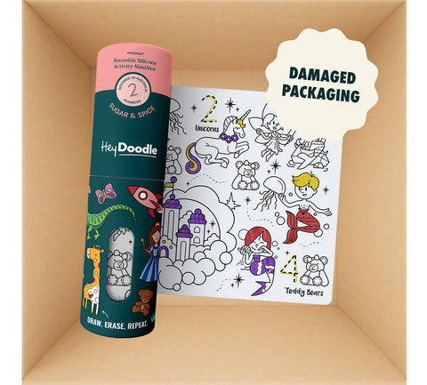 A teal cylindrical silicone canister and a rectangular silicone Mini Mats (Damaged packaging) activity mat featuring black-and-white line art of unicorns, mermaids, and castles, presented in a reusable silicone-friendly box.