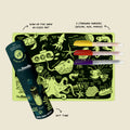 The HeyDoodle Glow-in-the-deep Mini is a silicone, glow-in-the-dark sea creature colouring mat with yellow, red, and purple markers in a gift tube on beige; labels show this reusable kids' set.
