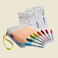 The HeyDoodle Australia Travel Bundle includes a soft pastel silicone case, eight vivid markers, and three reusable silicone colouring mats.